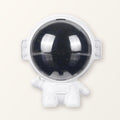 White astronaut star projector with a dark space-print visor on a plain cream background