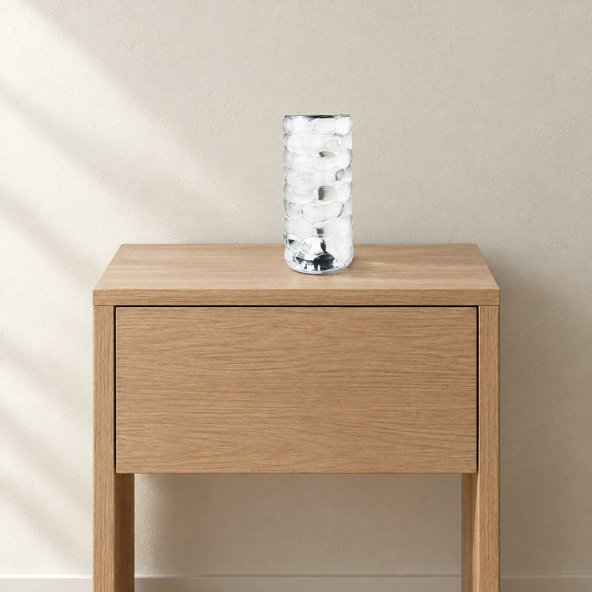 Crystal-look acrylic lamp, about 7 inches tall, on an oak nightstand for scale