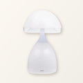 White mushroom table lamp with a frosted cap and bell-shaped base on a plain cream background