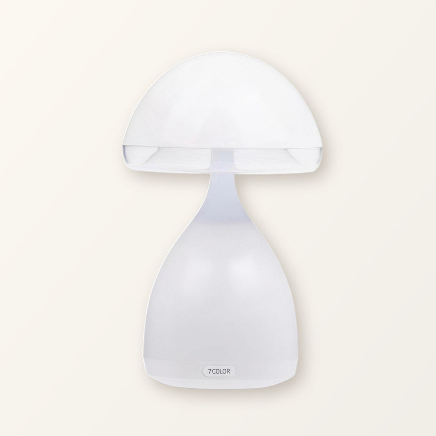 White mushroom table lamp with a frosted cap and bell-shaped base on a plain cream background