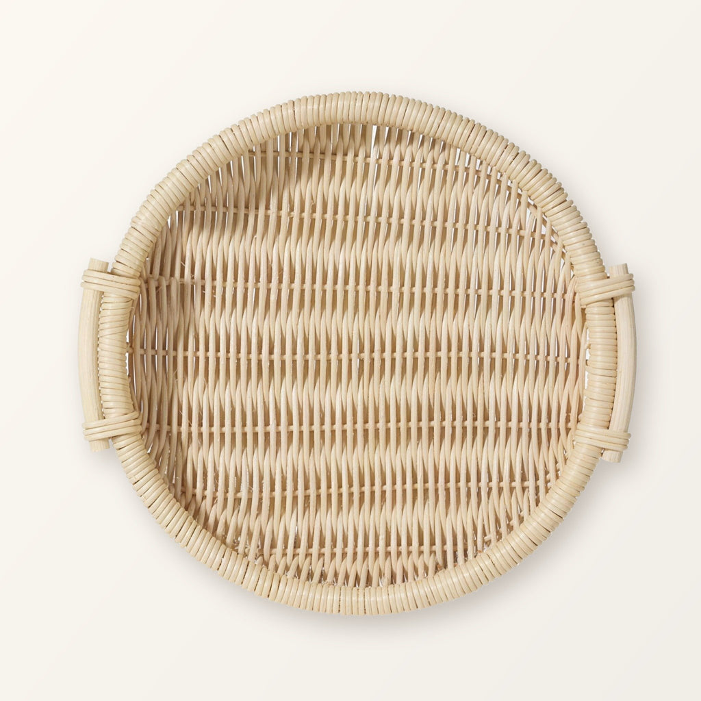 Round woven rattan tray with two side handles in pale natural rattan, seen from above