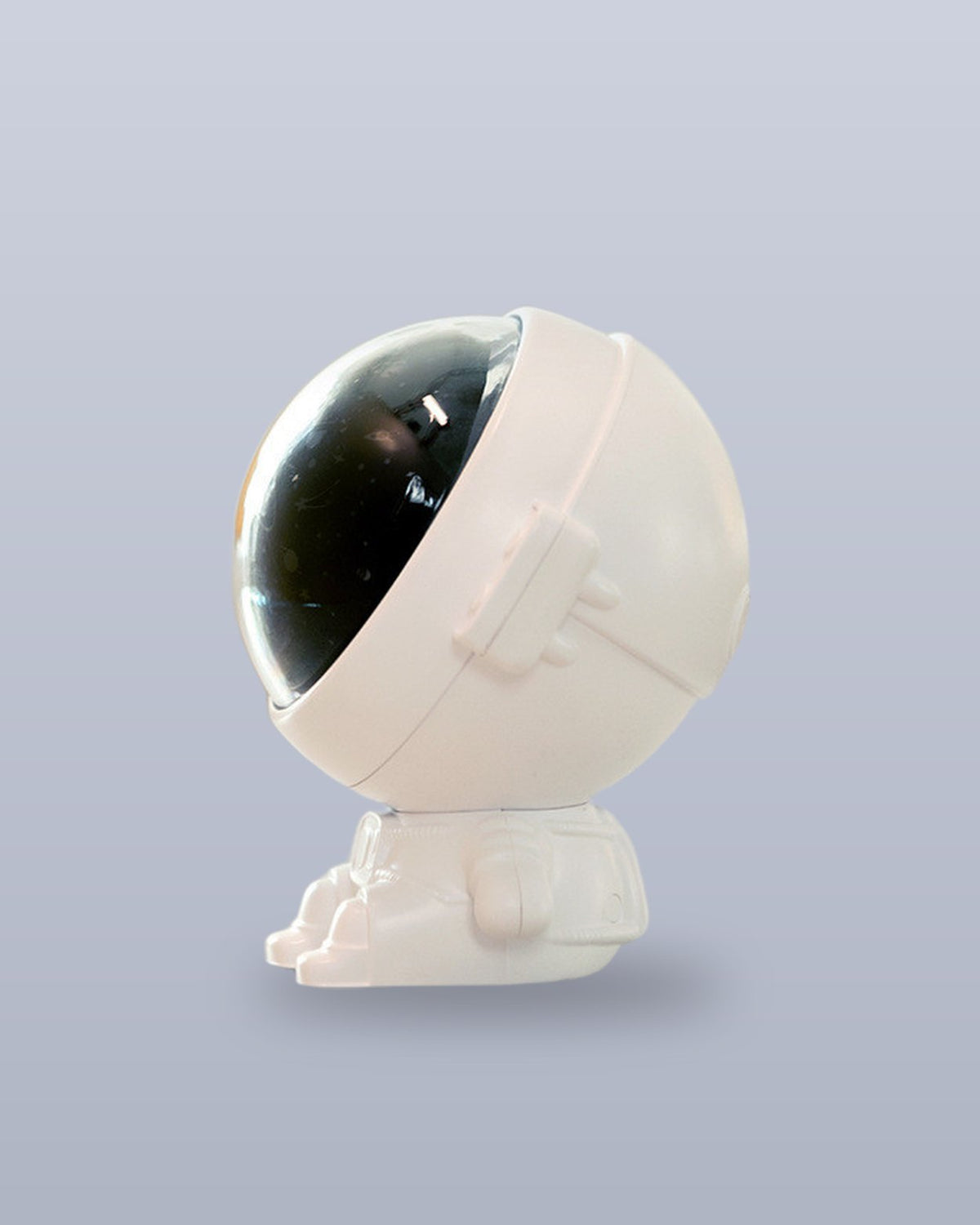 Astronaut projector seen from the side with its helmet tilted back to aim the projection
