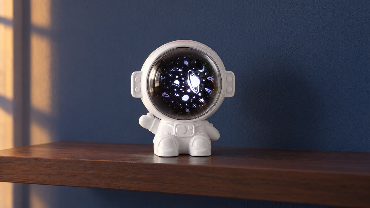 White astronaut star projector with its visor lit, on a walnut shelf against an indigo wall in early-evening light