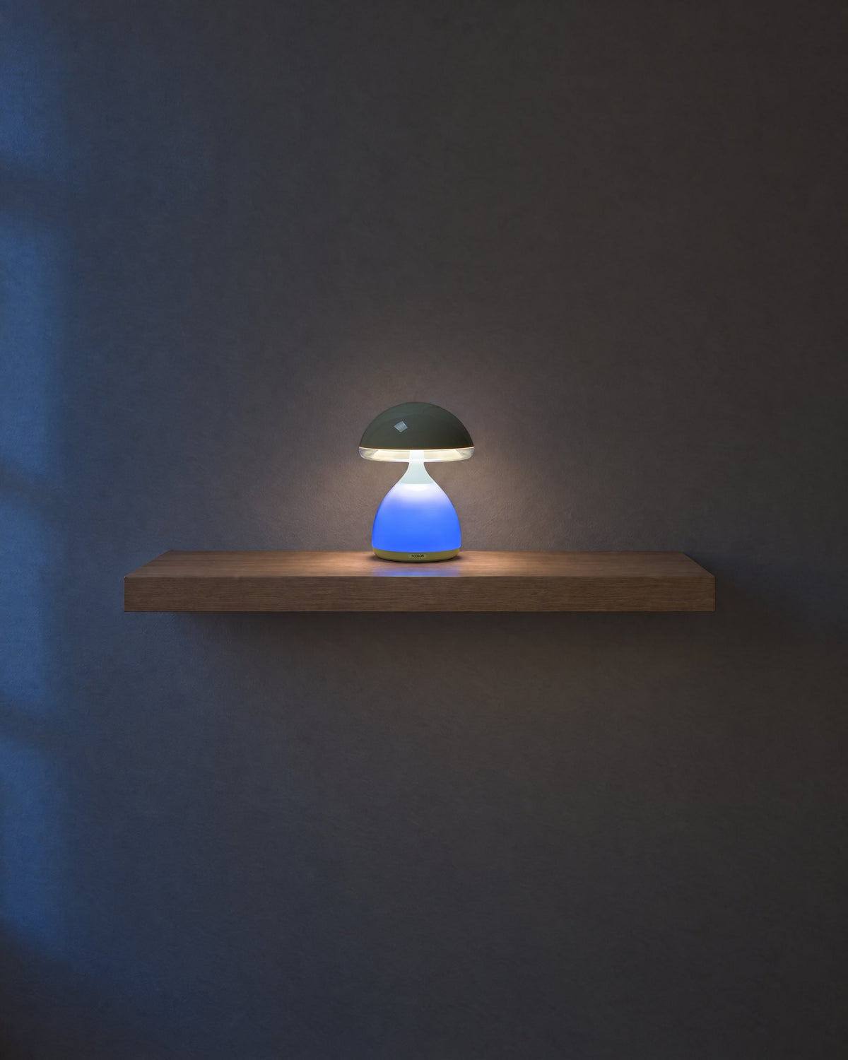 Mushroom lamp, 7.1 in tall, glowing blue on a 24 in oak shelf at dusk, drawn to scale