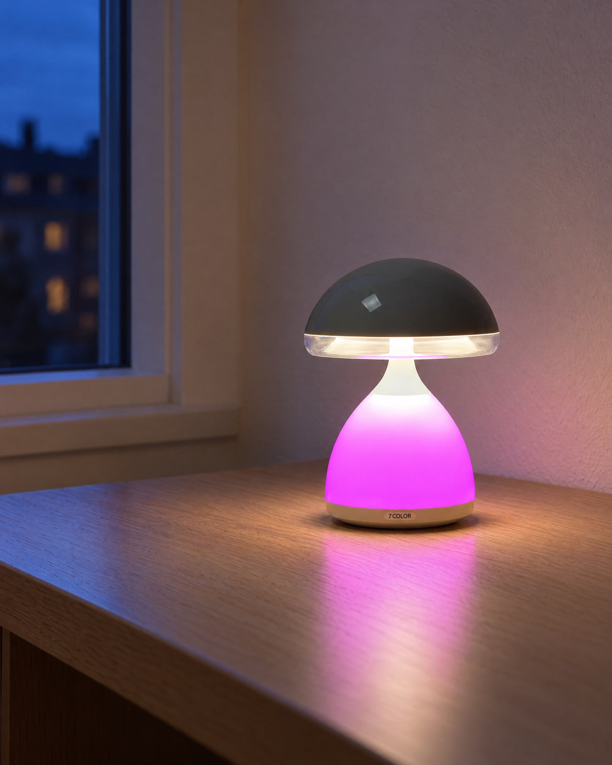 Mushroom table lamp glowing pink on an oak desk by a window at dusk