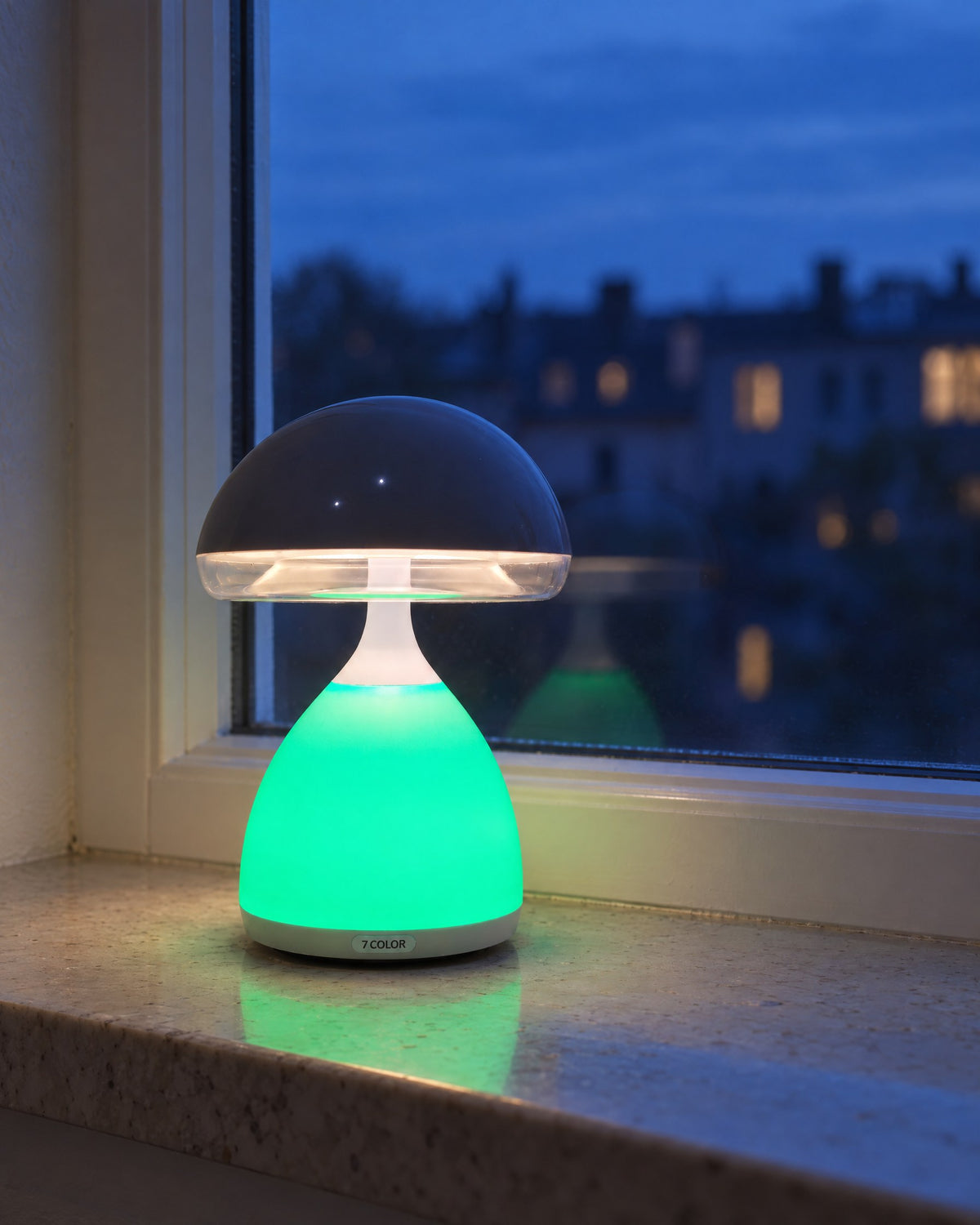The mushroom lamp glowing green on a stone windowsill at blue hour, warm white light under the cap