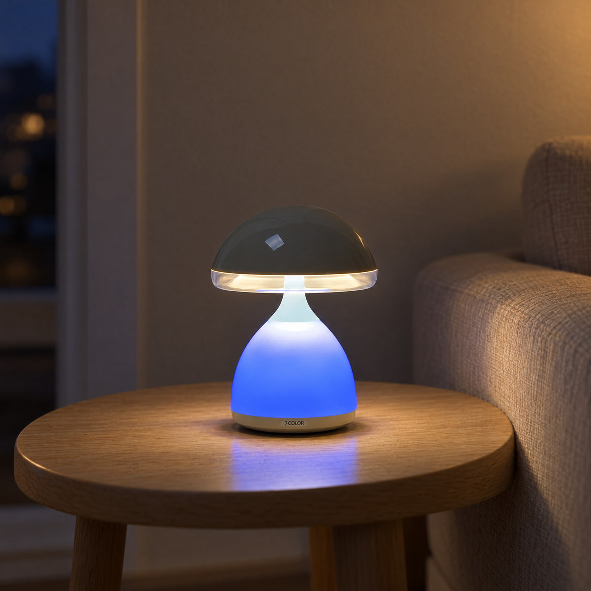 Mushroom table lamp with its base glowing blue on a round oak side table beside a linen sofa in the evening