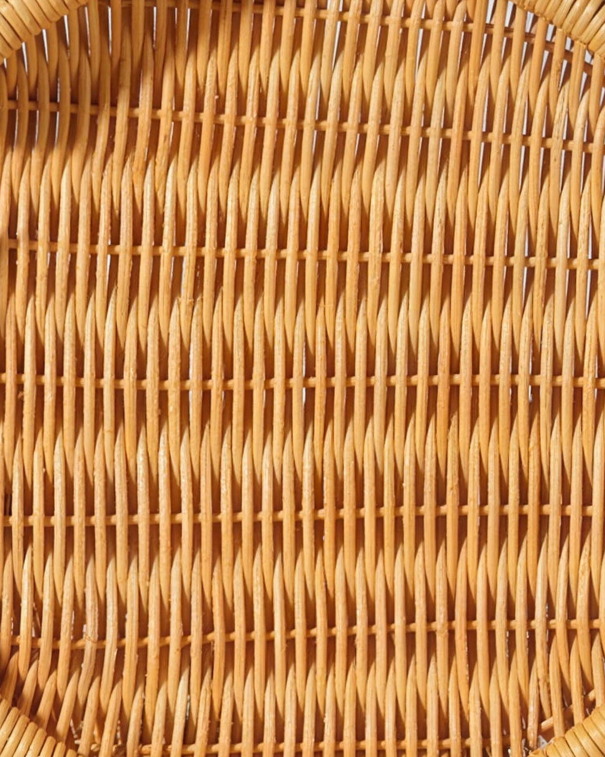 Close-up of the woven base of the round honey rattan tray