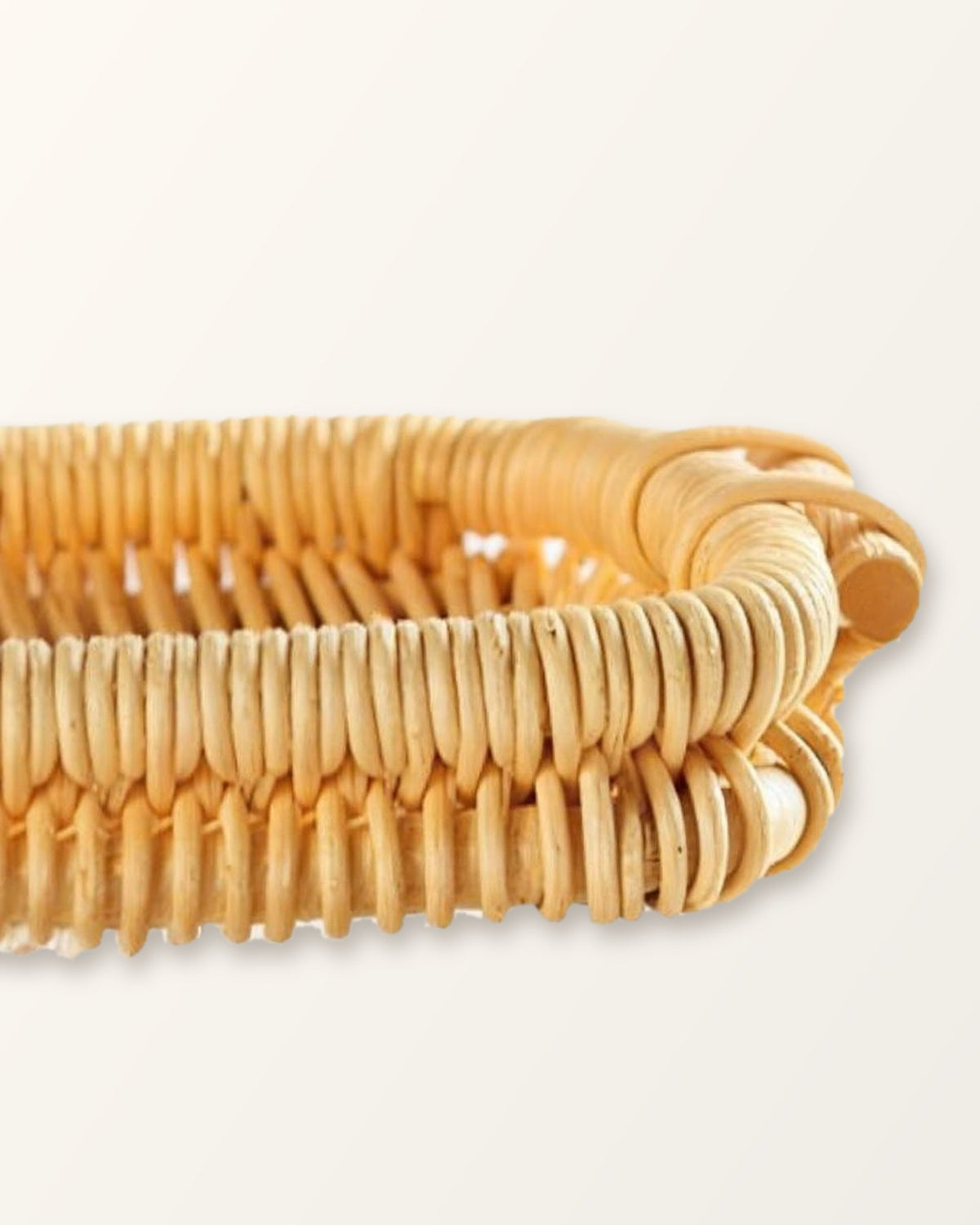 Side view of the rectangular honey rattan tray showing its low 1.4 inch rim and handle