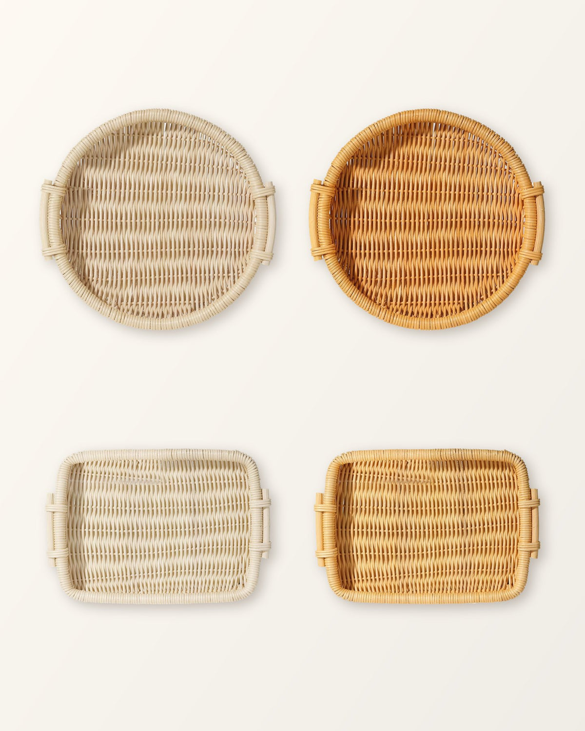 The four versions of the rattan tray: round and rectangular, each in natural and honey, seen from above