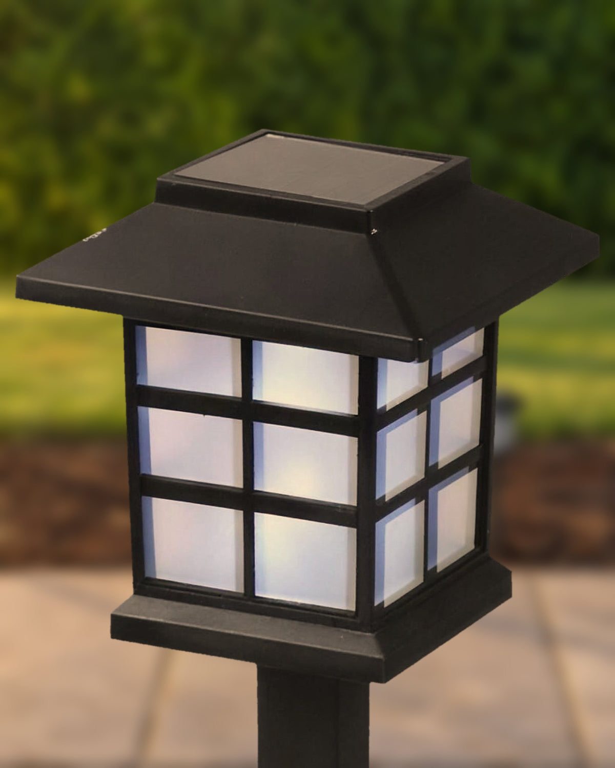 Close-up of the pagoda lantern head: solar panel in the roof, window-grid frame and frosted panels